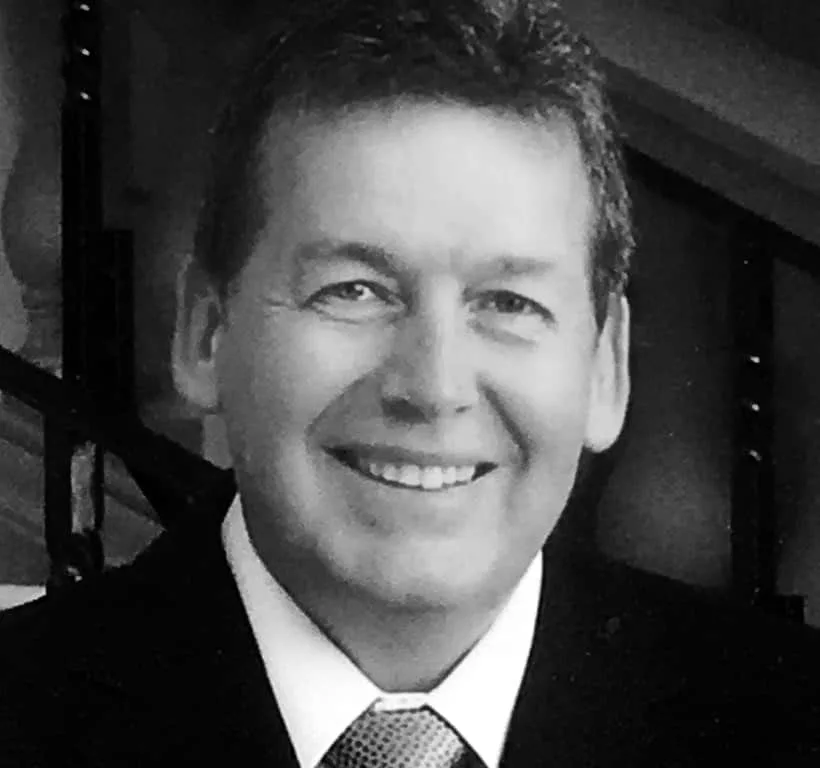 Man smiling and wearing a tie