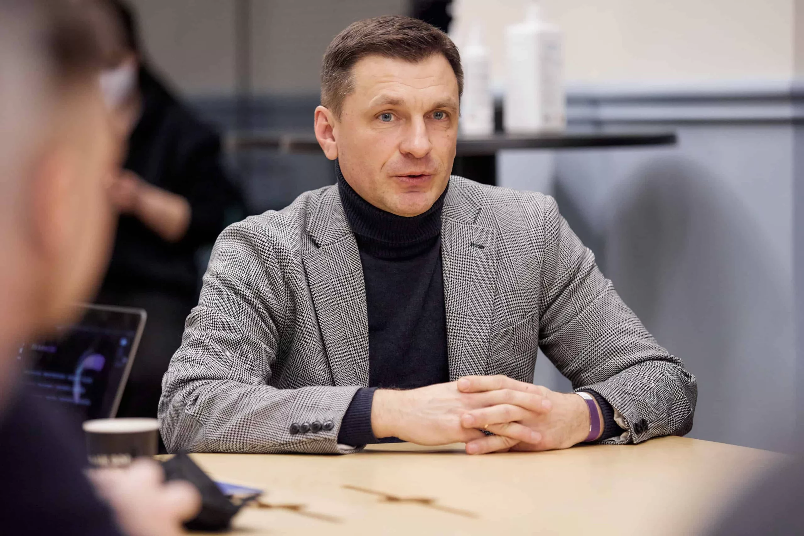 A man sitting at a desk wearing a suit