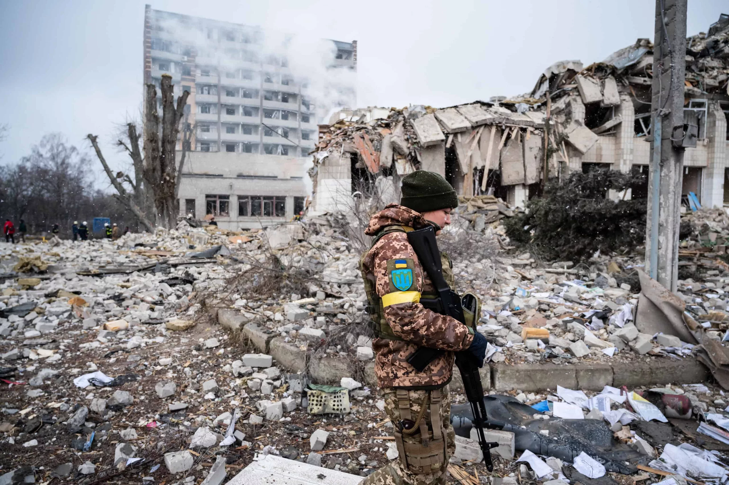 Aftermath of school shelling Ukrainian soldier stands in rubble of a bombed school