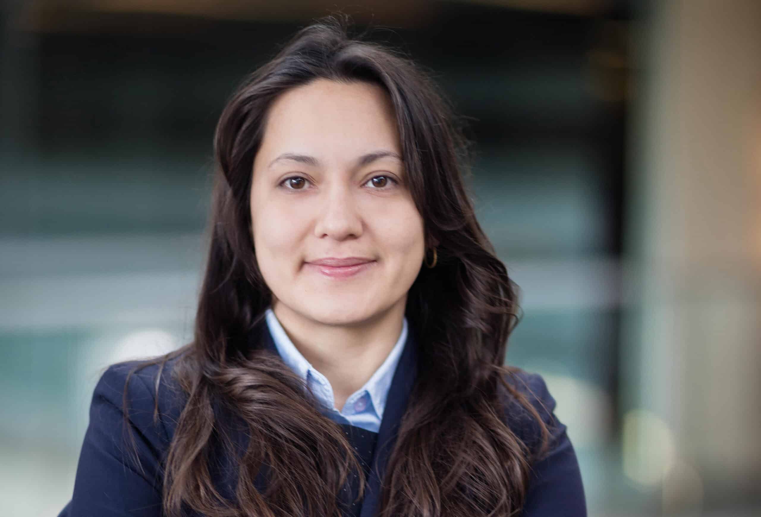 Woman with long dark hair smiling
