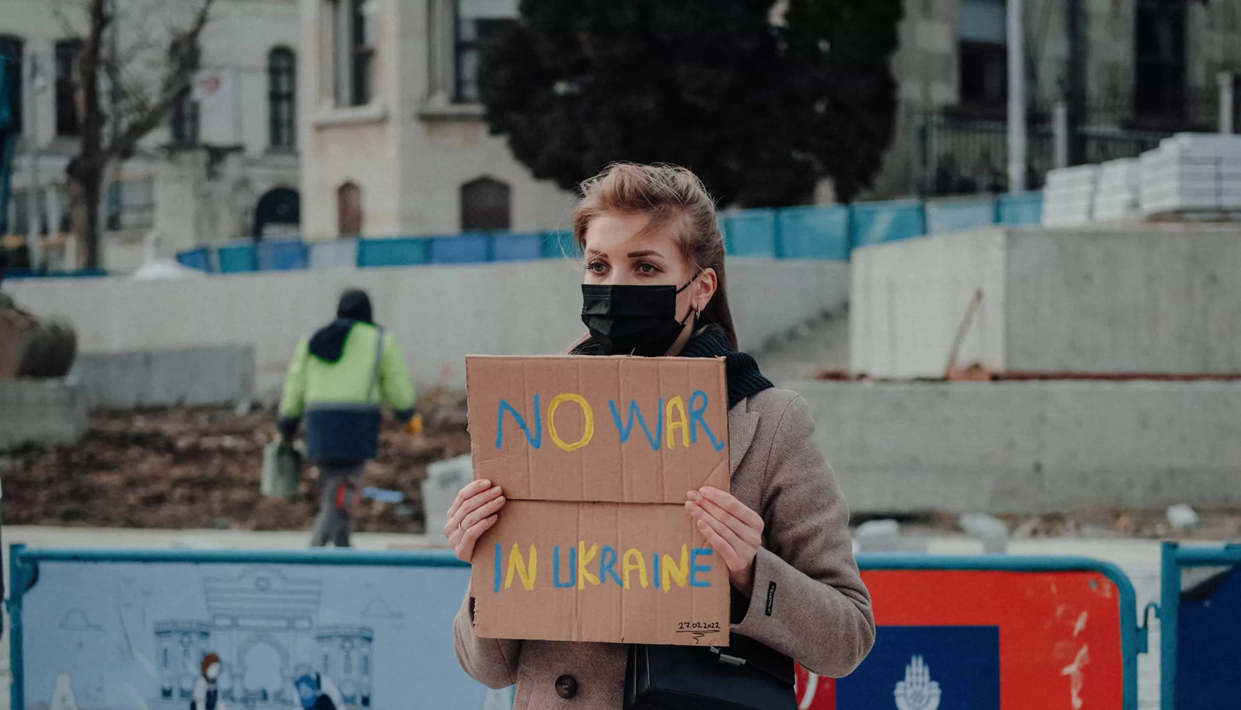 War protestor Female war protestor stands alone with banner