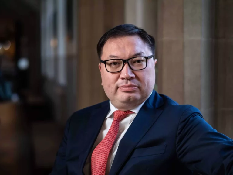 Portrait of a man in a suit wearing glasses