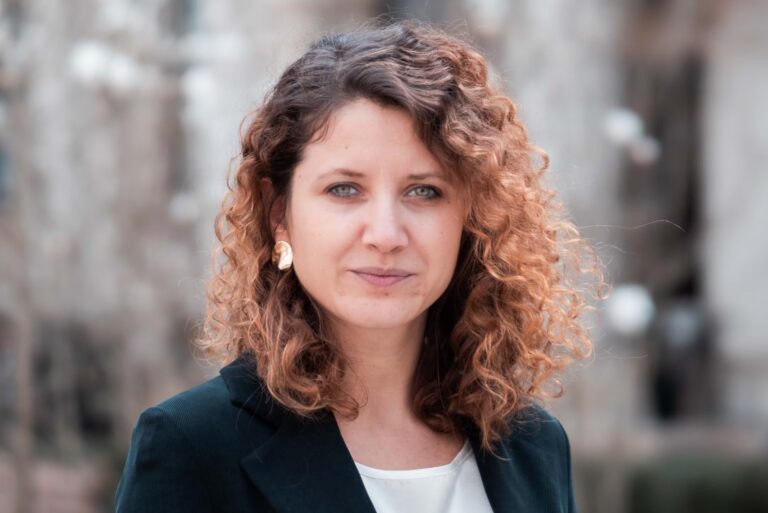 Hanna Liubakova stands outside looking at the camera