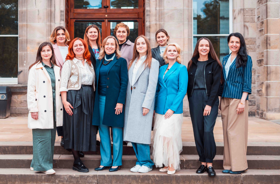 12 women / John Smith Fellows on steps in front of the Edinburgh Business School