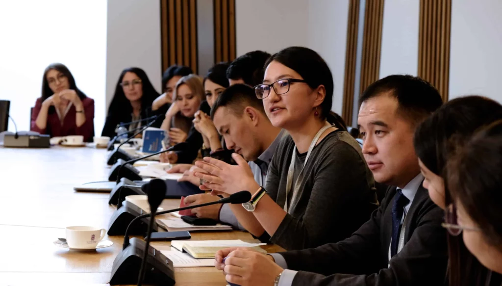 Fellows sitting at boardroom table