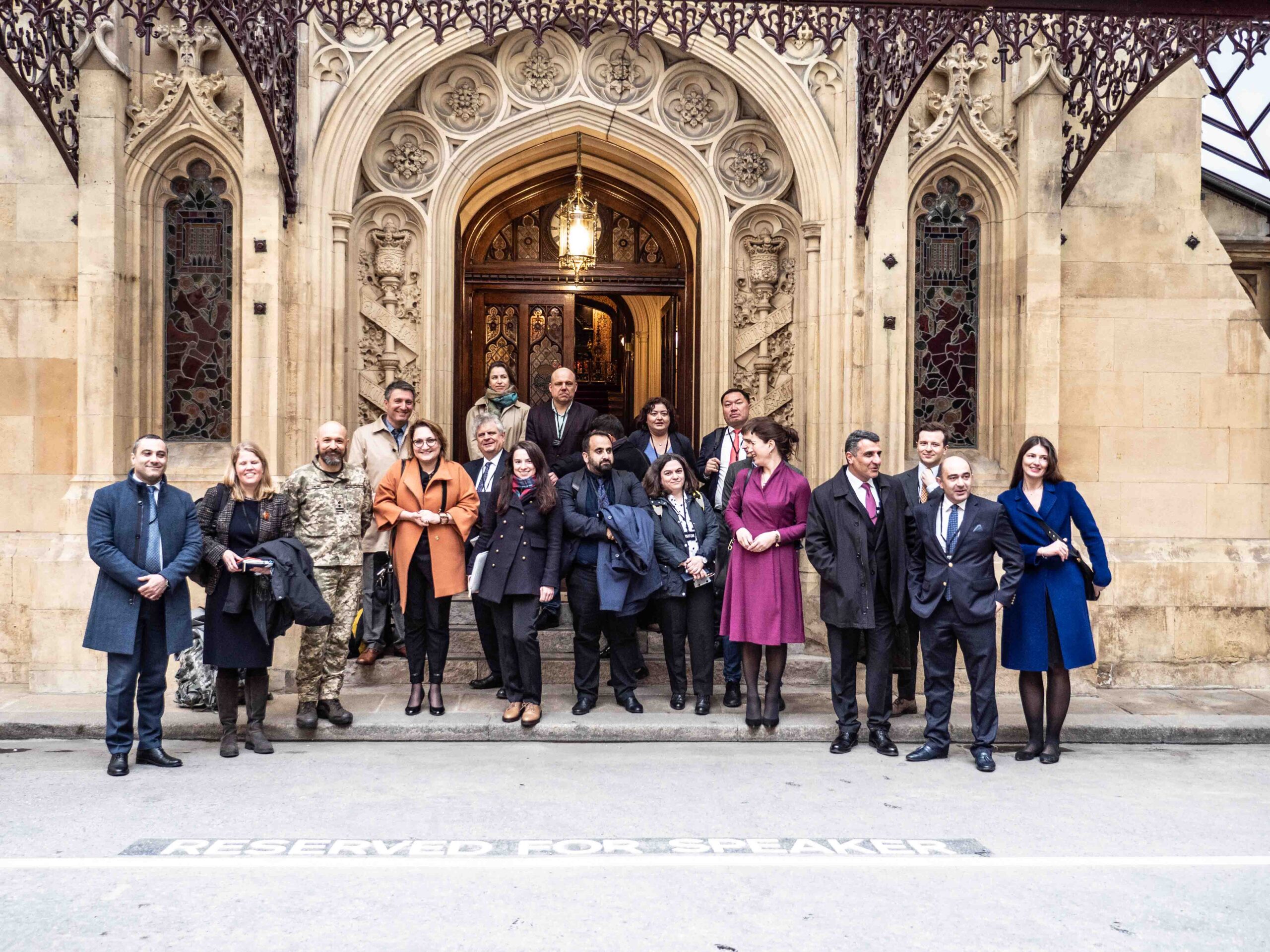 A group of JST Fellows standing in front of a grand entrance to Parliament