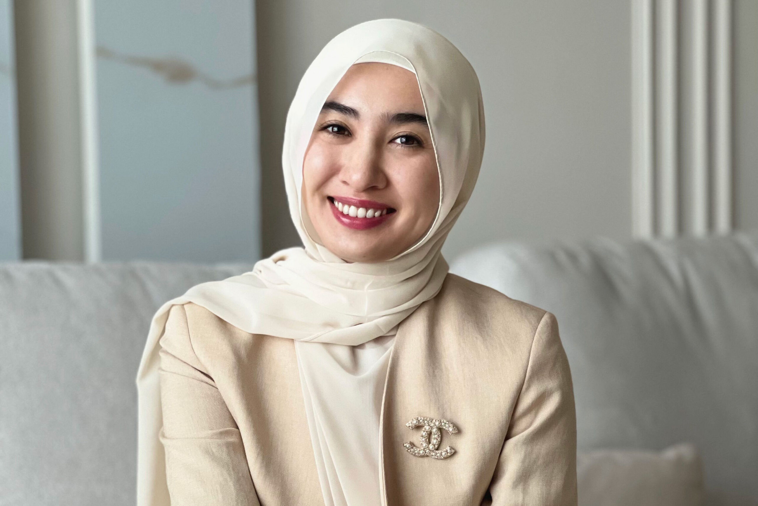 Botagoz A woman in a headscarf smiling
