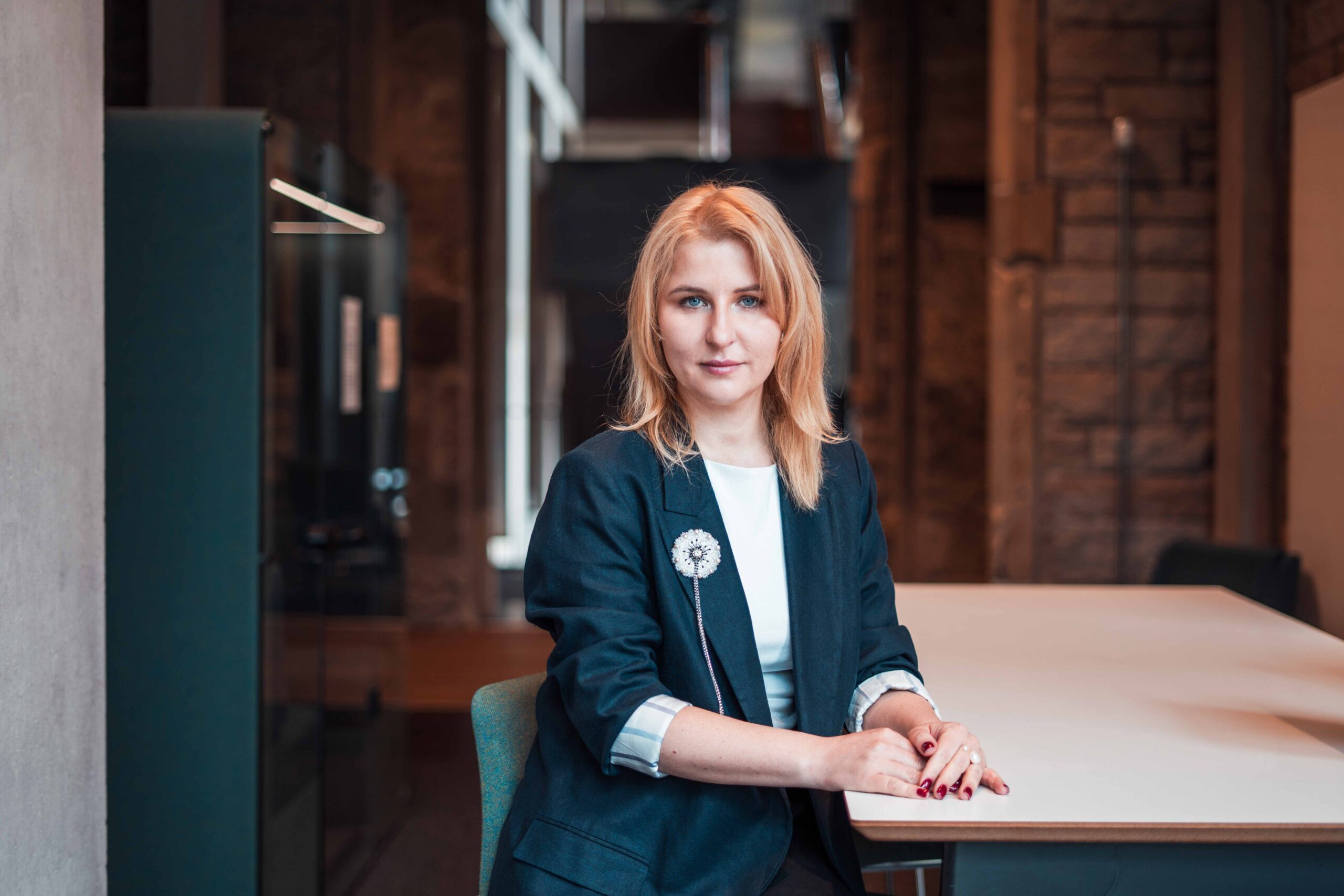Ukrainian Women's Leadership Programme Woman in a blazer sitting at a desk