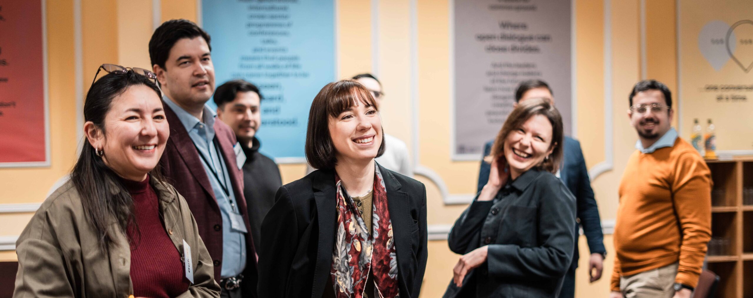 A group of Fellows in a room laughing together