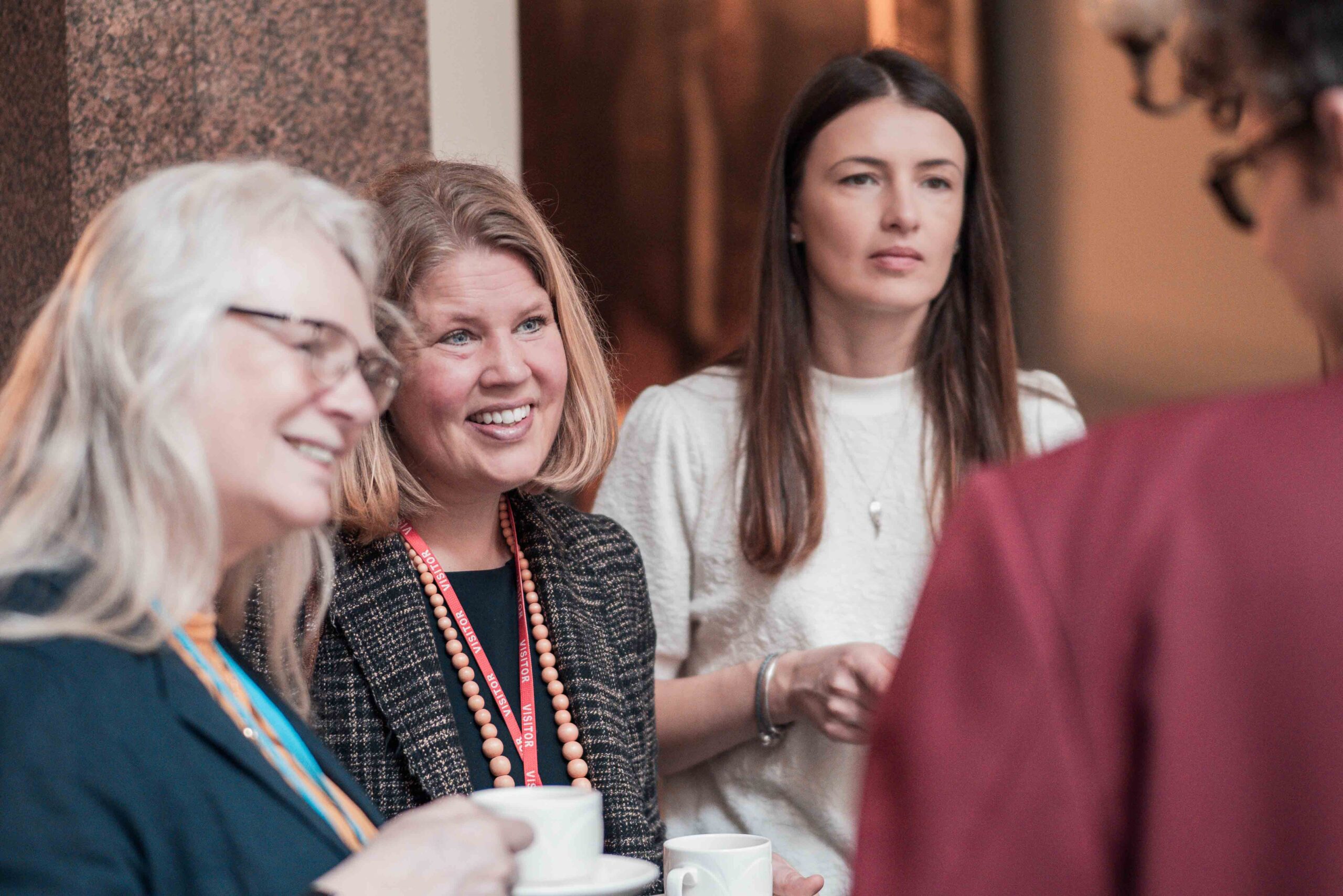 Networking at the FCDO Three women chatting over cups of tea