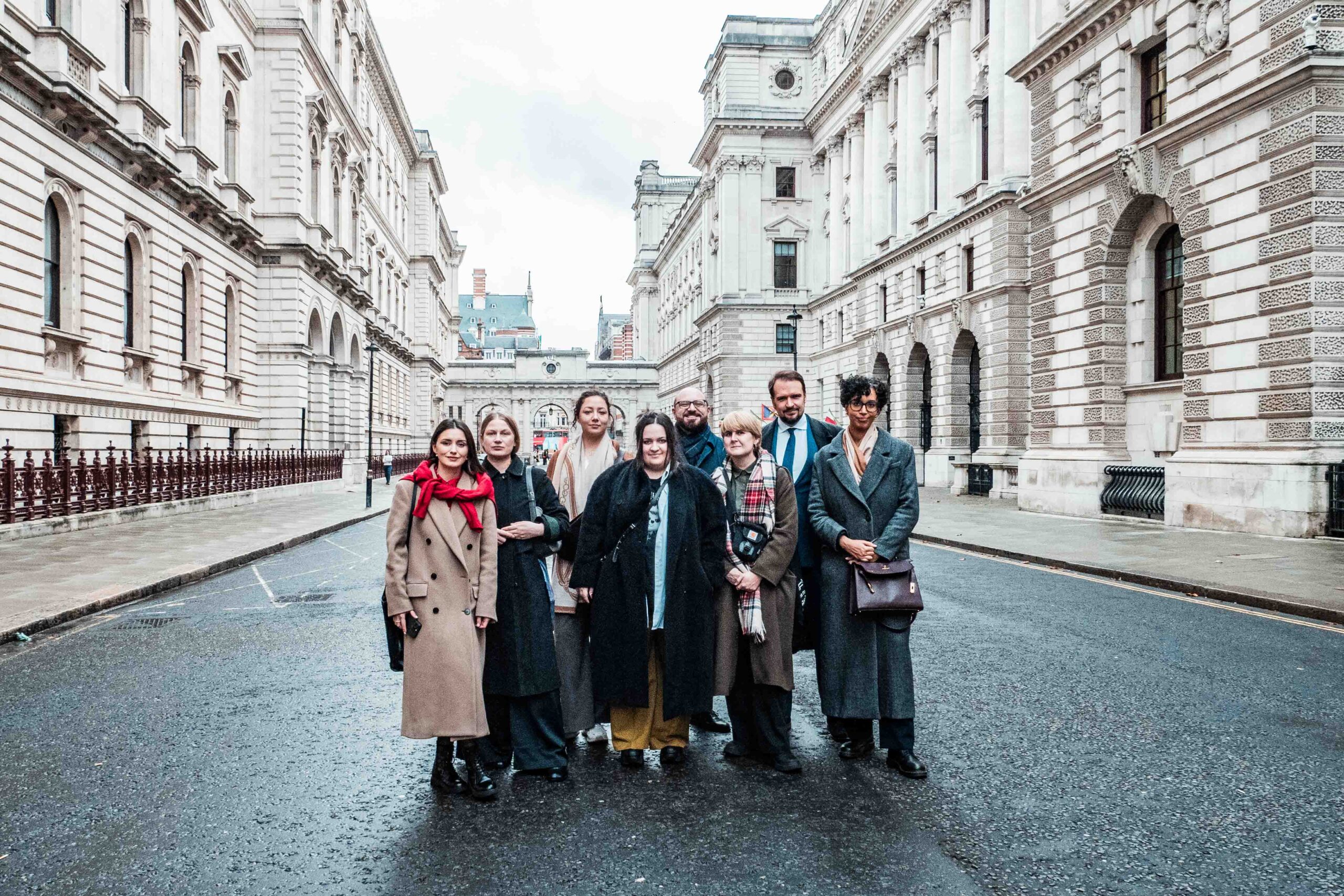 A group of Fellows standing outside the grand stone-build FCDO building
