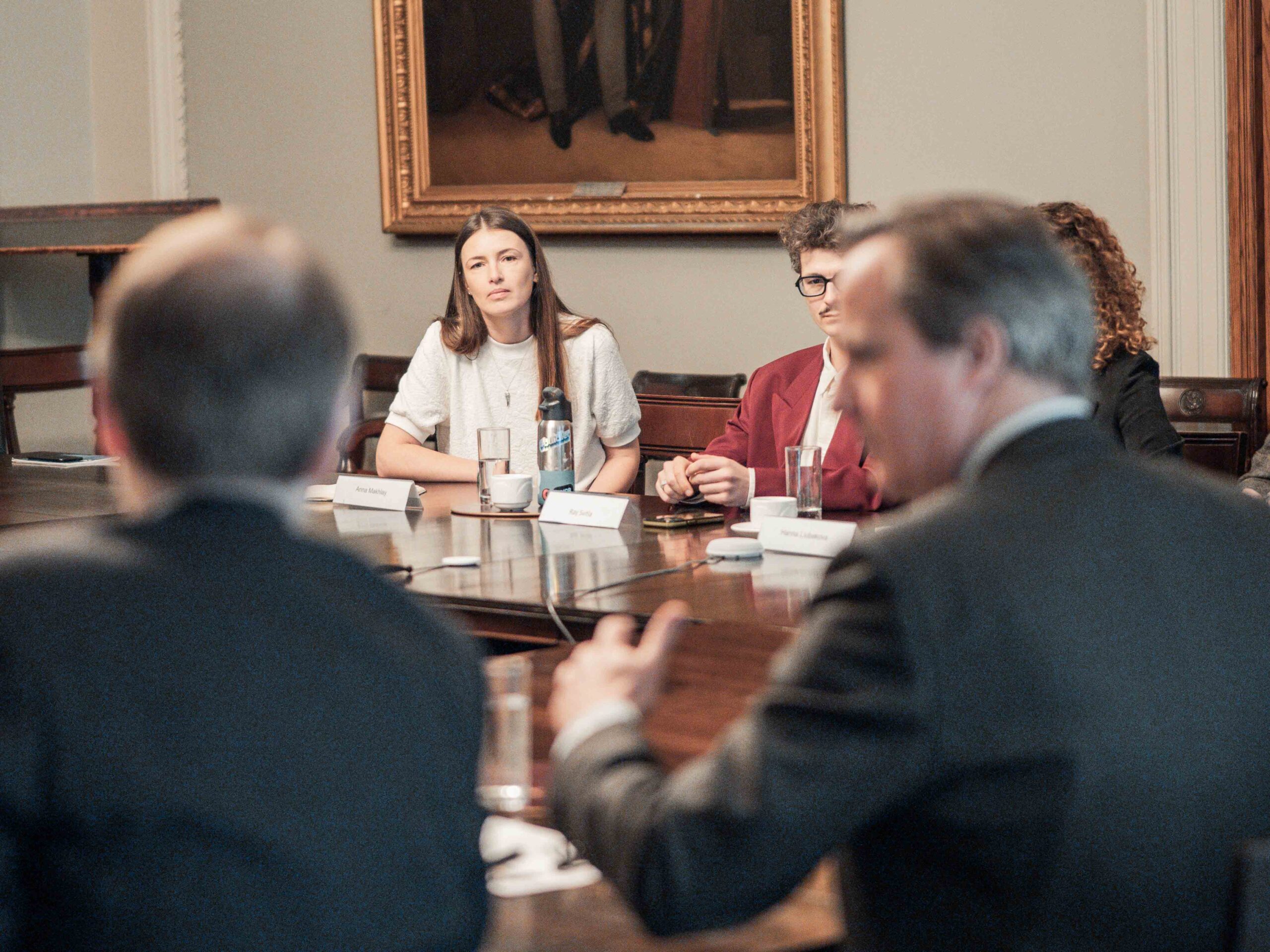 Fellows at FCDO Fellows in discussion around a table
